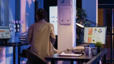 Business woman analyzing statistics on monitor and finishing management project before job deadline. Advisor agent working on financial diagrams and checking company analytics.