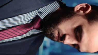 Vertical video: Male professional server IT engineer using laptop in data center, working on computer mainframe processor and running diagnostics on cloud computing connection, artificial intelligence