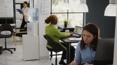 Corporate employee using online analytics to plan investment strategy for profit growth in business office. Young woman working on startup development with laptop, data statistics.