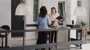 Diverse group of employees brainstorming growth ideas in corporate office, finding business solutions for development. Team of people doing project collaboration in briefing meeting.