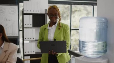 Office employee reading annual data report on screen, checking analytics before planning new company investment at desk. Young woman analyzing internet statistics, profit growth.