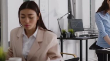 Young employee dealing with headache and working on computer, rubbing temples and feeling worried about pain. Female entrepreneur having painful migraine at desk, work under pressure.