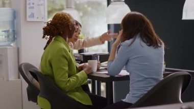 Business colleagues planning investment in meeting, talking about corporate partnership and analyzing statistics on documents. Women working on marketing vision in agency office.