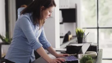 Female entrepreneur working on laptop to plan report, using online data analytics on computer. Young employee analyzing corporate statistics for management, professional project. Handheld shot.