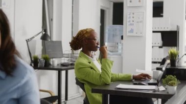 African american woman thinking about marketing vision and working on business development plan. Corporate employee brainstorming new ideas and solutions, help increase profit.