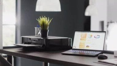 Office boardroom filled with statistics files and pc, empty workstation or desk in business department room. Corporation workplace in open space, interior of digital agency management.