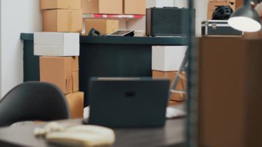 Warehouse room filled with goods and merchandise packages used for inventory and quality control, shipping products. Empty storehouse serving as small business space, shipment logistics.