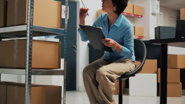 Woman Startup Owner Taking Notes Laptop Analyzing Stock Warehouse Products — Video