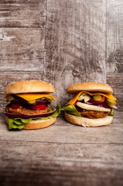 Burgers on wooden plate. Fast food. Unhealthy snack
