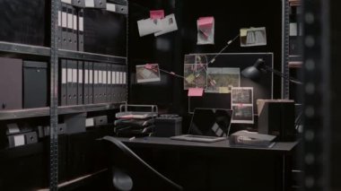 Detective evidence map with case clues on wall in archive room, crime scene photos and surveillance footage. Empty police office space filled with statements and records on board.
