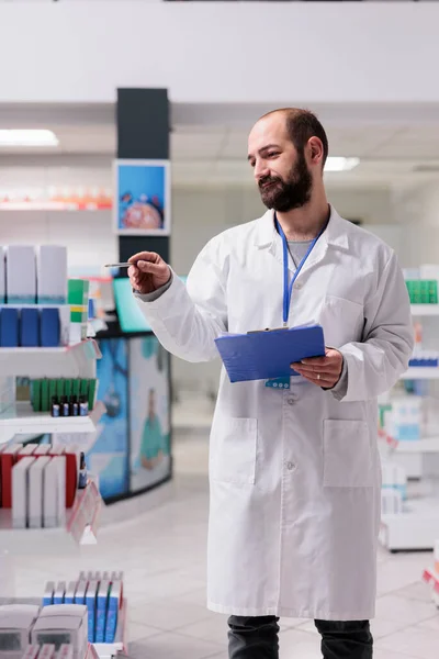 Drugstore Employee Holding Clipboard While Checking Pills Packages Writing Medication — Stock Photo, Image