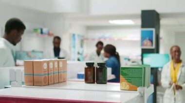 Young woman looking at medicaments and pills in pharmacy, checking boxes of vitamins on drugstore shelves. Female client buying prescription medicine against sickness, healthcare.