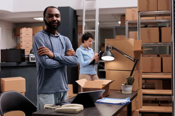 非洲裔美国人的画像 他们手挽手站在仓库里 为顾客准备包裹和纸盒 销售中心实现公司 — 图库照片