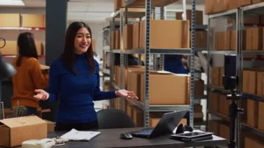 Business owner working on digital marketing with video, filming vlog for social media marketplace. Female entrepreneur making ad promotion campaign for development, teleshopping concept.
