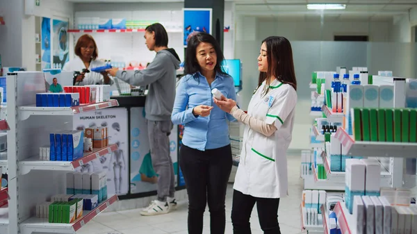 Asian Client Asking Assistant Advice Medicaments Sarching Prescription Medicine Bottle — Stock Photo, Image