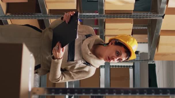 Vertical Video Young Woman Writing Stock Logistics Warehouse Looking Cardboard — Stock Video