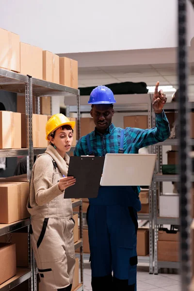 Warehouse Employees Comparing Inventory Data Clipboard Laptop Diverse African American — Stock Photo, Image