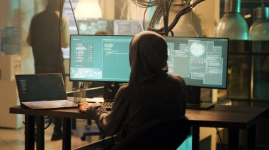 Professional web thief using malware to access system and steal sensitive information. Hacker doing phishing and planting virus to create security breach, hacktivism and cryptojacking.