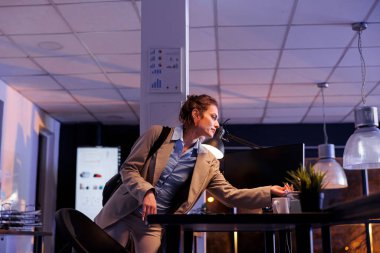 Yönetici yönetici şirket stratejisini gece geç saatte bitiriyor, şirket ofisinden ayrılmaya hazırlanıyor. Açılış ofisinde pazarlama istatistiklerinde mesai yapan yönetici. İş konsepti