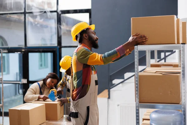 Warehouse Package Handler Choosing Cardboard Box Shelf While Standing Ladder — Stock Photo, Image