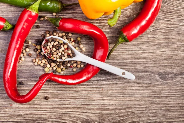 stock image Spicy red and green pepper on wooden background in studio photo