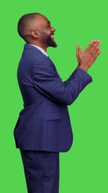 Dikey video: Olumlu iyimser bir yetişkinin el çırpma ve alkışlama profili, yeşil ekran arkaplanı üzerinde poz veriyor. Genç işadamı destek veriyor ve tebrik ediyor, ayakta alkışlıyor