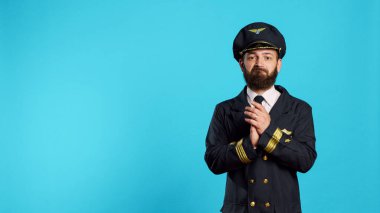 Professional airliner doing applause and cheering, saying congratulations and clapping hands in studio. Airplane captain in uniform with positive emotions doing standing ovation gesture.