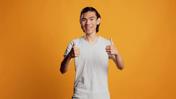 Carefree Guy Giving Thumbs Camera Expressing Agreement Okay Sign Smiling — Stockfoto