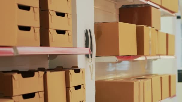 Empty Warehouse Landline Phone Wall Shelves Racks Filled Merchandise Cardboard — Stock Video