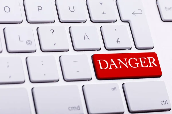 stock image Alluminium keyboard with DANGER word written on red button close up photo