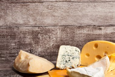 Ahşap arka planda farklı bir peynir türü. Gurme yemek aperatifi