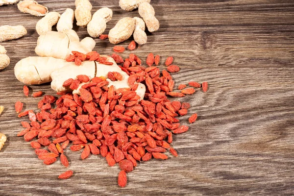 stock image Raw organic food and nuts on wooden background. Over top view