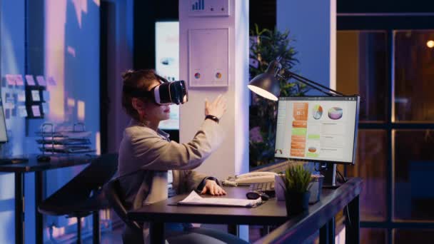 年轻的女商人晚上戴着眼镜工作 在办公室加班经济发展 使用虚拟现实耳机 计划财务图表的女经理报告Pc — 图库视频影像