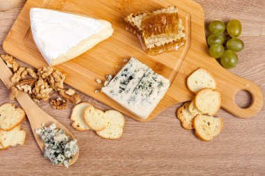 Görünümü ile fındık, peynir, üzüm ve kraker vintage ahşap arka plan stüdyo fotoğraf üzerinde plaka üzerinde katmayın. Sağlıklı yaşam tarzı