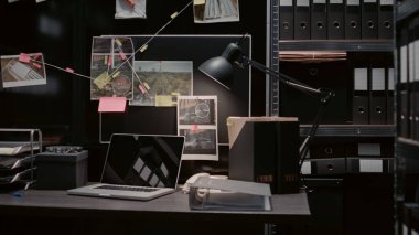 Detective evidence map with case clues on wall in archive room, crime scene photos and surveillance footage. Empty police office space filled with statements and records on board.