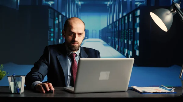 System administrator working in data center render farm, creating cloud computing service for innovation and digitalization. Database admin using big hardware data in server room.