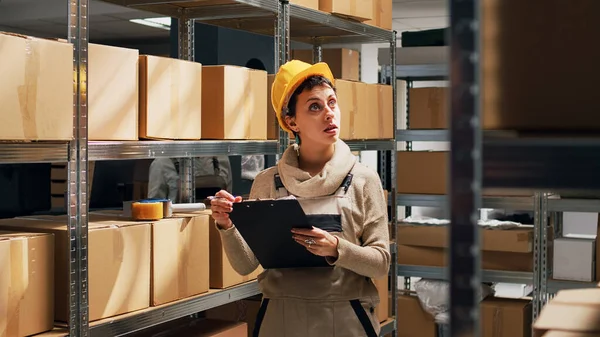 Young Woman Writing Stock Logistics Warehouse Looking Cardboard Boxes Shelves — Stock Photo, Image