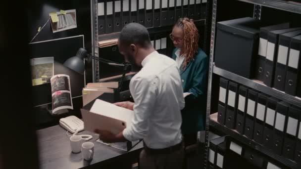 Two Police Officers Talking Surveillance Footage Archive Room Analyzing Criminal — Stock Video