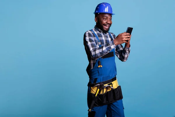 African American Builder Receiving Good News Text Message Cell Phone — Stock Photo, Image