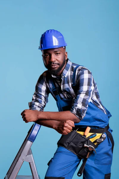 Builder Looking Calm Leaning Ladder Studio Shot Blue Background African — Stock Photo, Image