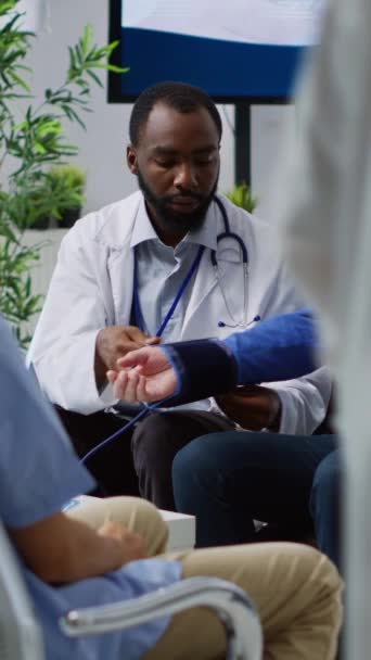 Vertikální Video Africký Americký Lékař Konzultuje Pacienta Měření Hypertenze Krevního — Stock video
