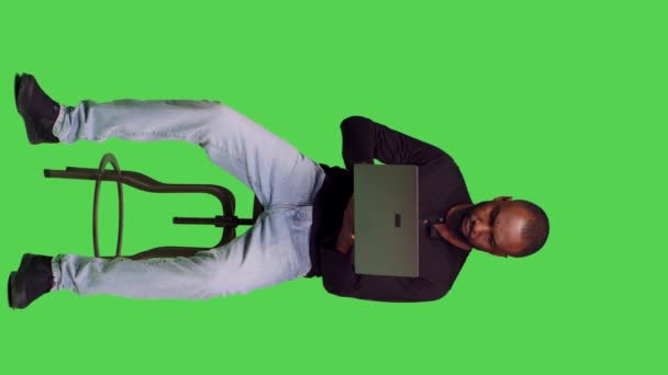 Vertical Video Front View Male Model Working Laptop Green Screen — Stock Video