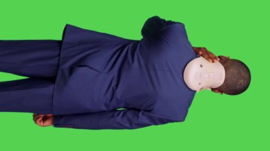 Dikey video: Acıyı dindirmek için boyun tasması köpüğü kullanan, tıbbi nedenlerden ötürü omurga yaralanması olan genç bir yetişkinin arka plan görüntüsü. Takım elbiseli ofis çalışanı yeşil boyunluk takıyor.