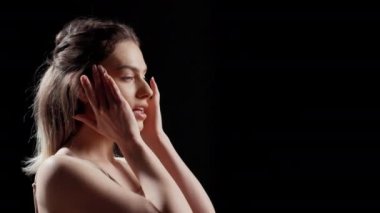 Elegant person doing skincare campaign with bare skin, posing on camera for natural products ad. Young beauty model acting glamorous and gentle, being happy with beauty routine.