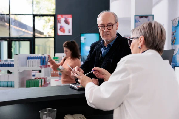 Elderly Pharmacist Standing Drugstore Counter Looking Client Health Care Prescription — Stock Photo, Image