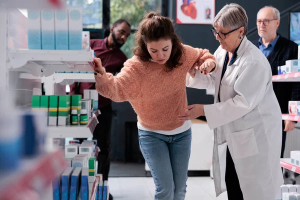 Elderly Drugstore Worker Helping Dizzy Customer Fainting Pharmacy While Diverse — Stock Photo, Image