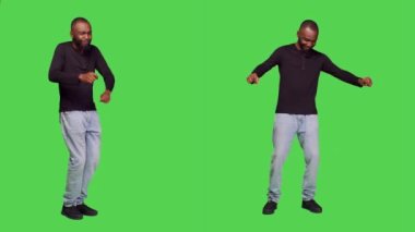 Dans figürlerini gösteren neşeli bir manken ve tüm vücudun önünde aptalca davranan bir manken. Delikanlı dans ediyor, dans ediyor, stüdyoda kendini neşeli hissediyor. Boş zaman aktivitesi.