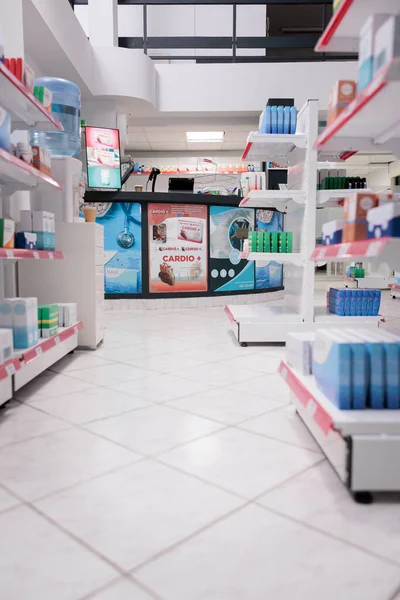 Empty health care facility with medicaments containers and supplements packages, retail shop shelves with pharmaceutical products. Pharmacy space filled with medical supplement and pills bottles.