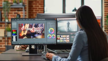 Graphic designer creating professional movie content with filmmaking software in agency office, creative digital film. Cinematographer editing video footage with lighting and focus, videography.
