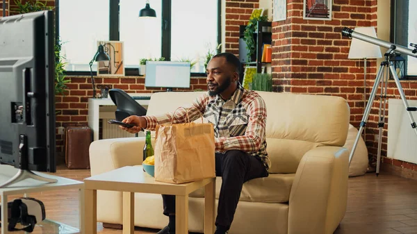 African American Man Opening Food Delivery Bag Living Room Preparing — Stok fotoğraf
